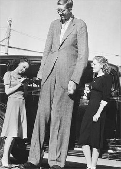 sixpenceee:  Robert Wadlow was the tallest person in history (1918-1940). He was 8 ft 11.1 in tall or 2.72 meters. His great size is due to his pituitary gland having a proliferation of cells. This resulted in increased levels of human growth hormone. 