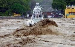 peaceful-moon:  A partially submerged statue of Shiva stands in the flooded River Ganges in Rishikesh, in the northern Indian state of Uttarakhand, June 18, 2013  Source 