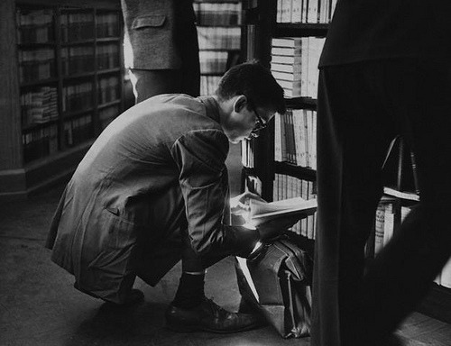 slanting:    An Oxford student looking through a book on saleEngland, 1950   