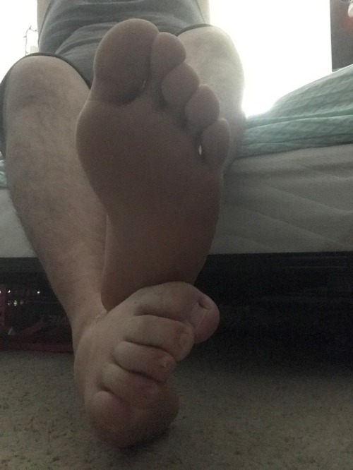How does it feel to be under my big feet? On second thought, no talking. Just get to licking.