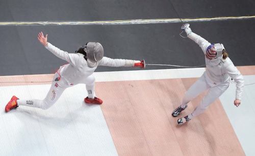 modernfencing: [ID: a sabre fencer lunging as her opponent retreats.] Fencing at 2017 Pan Ams! Photo