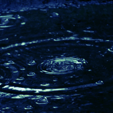 A gif of rain. The overall color is dark blue with yellow highlights