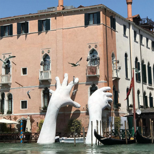 thedesigndome:Massive Hands Merge From The Water Reaching For Help Amidst the Dangers of Climate ChangeWhile we would al