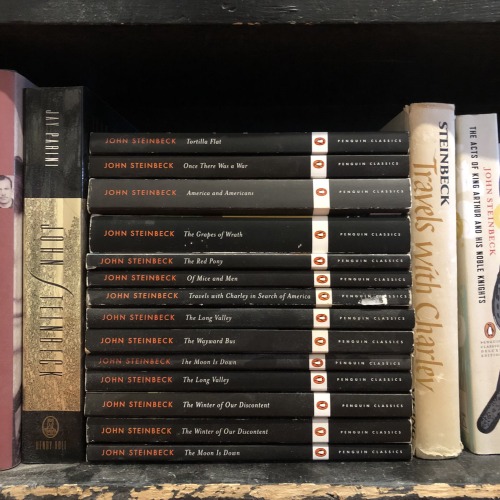 macrolit:A stack of Steinbeck Penguin Classics on a dusty bookstore shelf(aka Heaven)