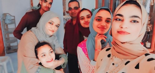 A photo of the Abu Mousa family. Shahd's brother and father, Firas and Hatem, are standing in the back. Shahd's mother, Maysoon, is embracing the youngest daughter, Joud. Shahd is standing to the right with her sisters, Lyan and Batoul.