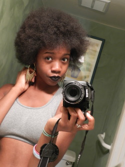 18-15n-77-30w:  Black lipstick, huge afro,