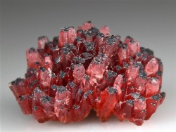bijoux-et-mineraux:  Rhodochrosite with Hematite crystals -  N'Chwaning I Mine, N'Chwaning Mines, Kalahari Manganese Fields, Northern Cape Province, South Africa