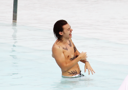 harrystylesdaily:  Harry enjoys a relaxing afternoon by the Fasano Hotel pool on May 7, 2014 