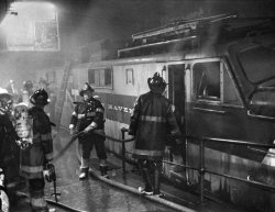 March 28, 1967: Firemen at the scene a fire on a track at Grand Central Terminal, where a fire on a train of the New Haven line sent smoke billowing through the station and into the Pan Am building and prompting evacuations. “The smoke was pouring...