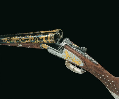 A very ornate 12 gauge double barrel shotgun decorated in the style of 19th century gunmaker Nicolas