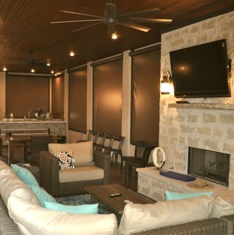 Large Tuscan Sunroom Photo With A Standard Fireplace And A Stone Fireplace