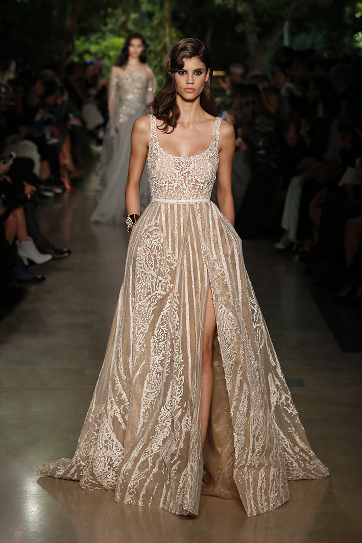 eliesaab:Ivory couture gowns dressed with lace and feathers, sequins and pearls.