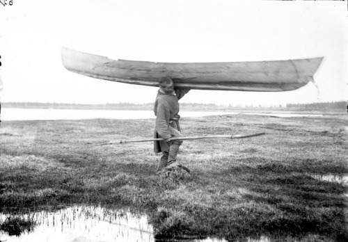 splattergut:Yakut fisherman carrying canoe, Siberia. (date unknown)