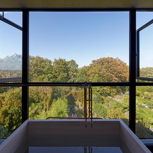 Good wood - I mean, what an awesome idea… a wooden bathtub in a loft extension overlooking a 