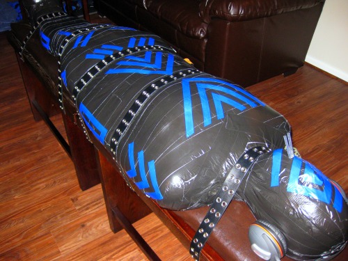 bondagejock: Mummified and strapped down. Totally immobile and restricted breathing through a drinki