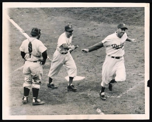 Duke crosses the plate.