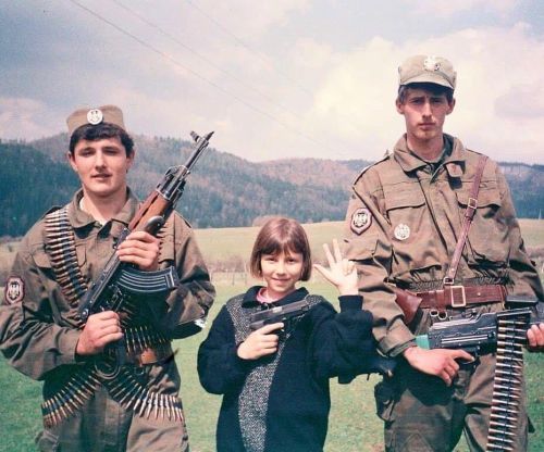 Two young Serb volunteers and a little girl pose for a camera during the Yugoslav Wars, Croatia, 199