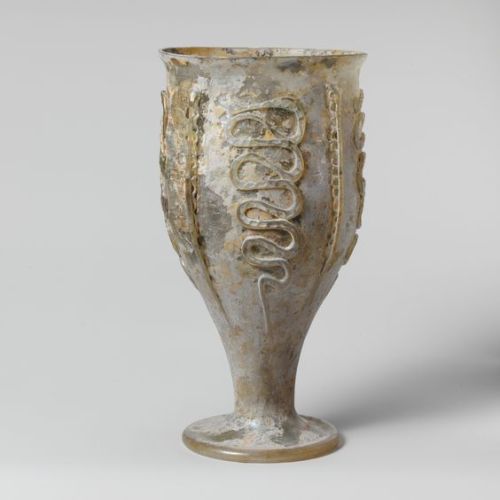 ivory-lace-and-sunlight:Glass beaker with snake-thread decoration -   Late Imperial, 3rd century A.D