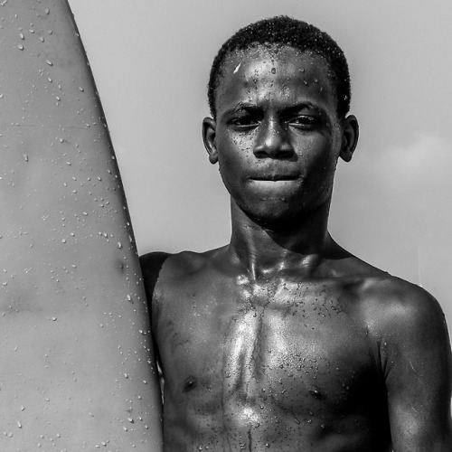 Monday is a young surfer on Tarkwa Bay, Lagos. He learnt mostly by observing and practice - spends a