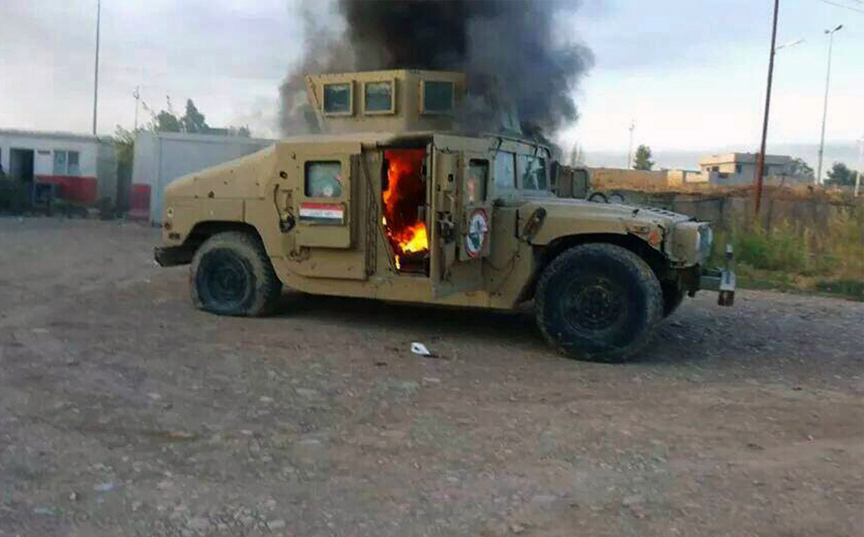 From Iraqi Insurgents Capture Northern Cities, Move Toward Baghdad, one of 19 photos. A picture taken with a mobile phone shows an armored vehicle belonging to Iraqi security forces in flames on June 10, 2014, after hundreds of militants from the...