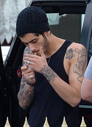 direct-news:  Zayn Malik puffs on a cigarette outside his £24-a-night hotel as he