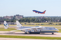 emmanuelcanaan:  A Southwest Airlines 737-7H4 departing Minneapolis helps provide some perspective as to just how massive the Antonov An-225 in the foreground is. The Antonov 225 is the largest aircraft in the world, and the only one of its kind.