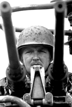 vietnamwarera:  A sailor mans twin .50 caliber machine guns of a swift boat, Cua Lon River, Mekong Delta, 1969.