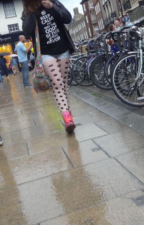 White and black polka dot pantyhose under tight short caught in the street.Woman in pantyhose