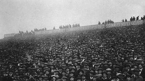 Fans crowd into White Hart Lane to watch a match featuring Tottenham Hotspur Football Club, early 19