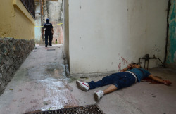 druglxrd:  The body of a young man, who was shot to death, lies on the ground at the Pacific resort city of Acapulco, Mexico on Aug 23, 2011. A result of the War on Drugs.. 