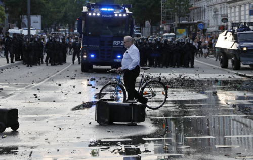 queeranarchism:  60 year old historian Martin Bühler (who identified himself to the press, I do not identify activists without consent) appears to ‘photobomb’ a lot of media images of the G20 in Hamburg. In reality he is a long time observer documenting