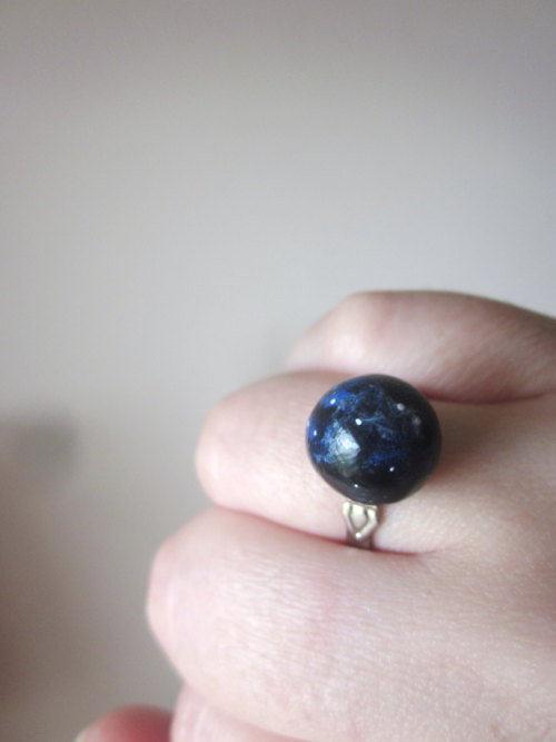 wickedclothes:  Planet Rings Bring outer space to the palm of your hand. Or to your fingers. Each of these rings resemble a piece of space. Featuring Neptune, Earth, the Sun, and a deep blue-colored galaxy, each of these rings are adjustable to fit your
