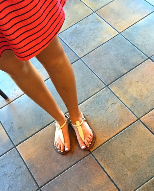 Sexy hot chick&rsquo;s beautiful face and pretty feet with white toenails candid at the coffee shop.