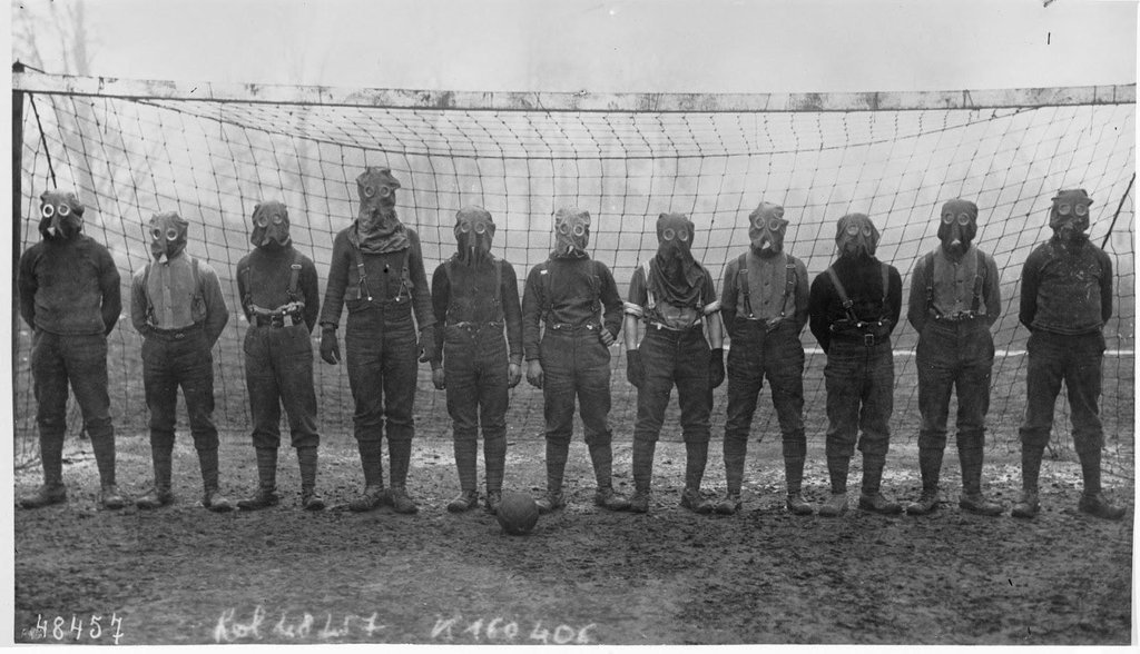 Soccer team of British soldiers with gas masks, World War I, somewhere in Northern