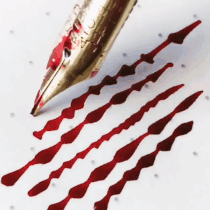 a fountain pen making lines of red ink