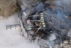 continuants:  Funtown Pier sign lies in the smoldering ruins in an aerial view of the devastation after a massive fire began yesterday in Seaside Park and spread north, wiping out 4 blocks of boardwalk attractions into Seaside Heights. 9/13/2013 (Andrew