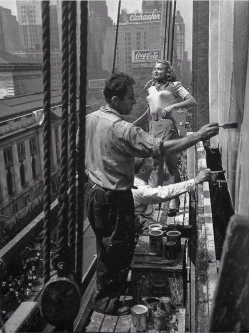 vintageeveryday:  A young woman’s likeness is painted on a billboard advertising, New York, 1947. 