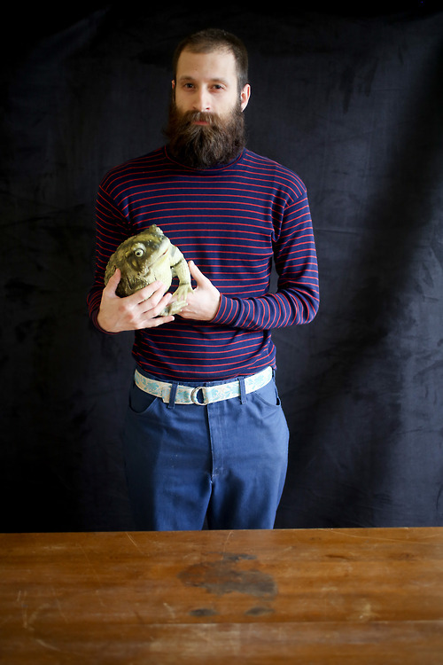 Matthew Lavoie - Collections Assistant, Botany, holding the model of a cane toad from the imaging lab.