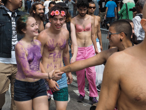 Girl makes friends with fellow marchers in Manhattan’s Manhattan’s 2015 Go Topless Pride Parade on N