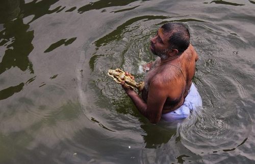 The aarattu (Holy bath) of Aykkunnu Baghavathi in the pond of Peruvanam temple Thrissur, Kerala, pho