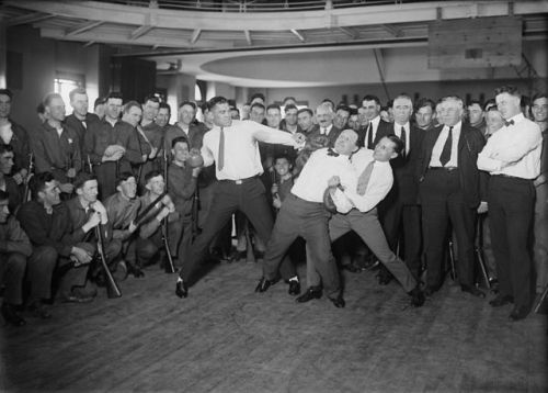Heavyweight boxer Jack Dempsey pretending to punch Harry Houdini.