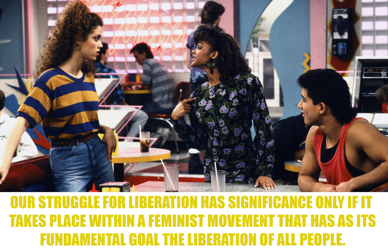 Image description: A still image from the 90’s TV sitcom Saved By The Bell. Jessie and Slater listen to Lisa who is pointing at herself. The caption reads, “Our struggle for liberation has significance only if it takes place within a feminist...