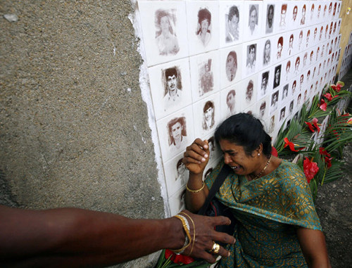 unearthedviews: Raddoluwa, Sri Lanka: A mother cries near a photograph of her missing son at a memor