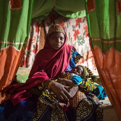 Nana Balki Abdou holds her newborn son Asmau Mauzu. Nana was chosen by her community in Niger to be a leader mother in her local mother care group. Mercy Corps trains leader mothers on proper healthcare and nutrition so they can teach other mothers...