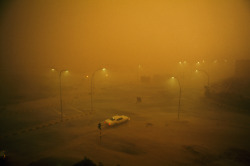 natgeofound:  A combination sand and rain storm batters a lone automobile in Kuwait, May 1969.Photograph by David Cupp, National Geographic 