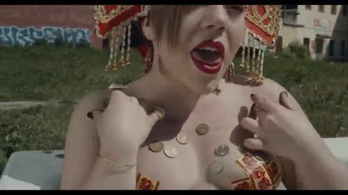 Olympia Ivleva of the fabulous Russian cultural terrorism group LITTLE BIG takes a golden bath in their video “Give me your money”.