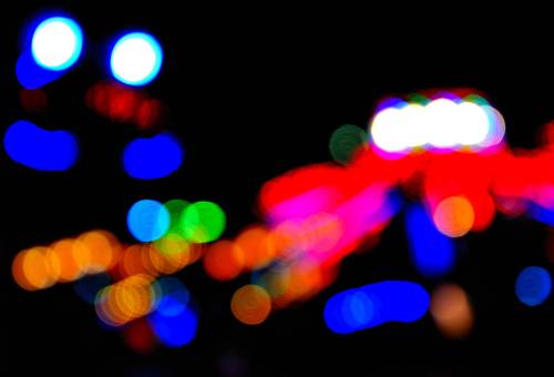 Fairground BokehNight abstract of whirling fairground amusement rides.Cheshire, England   SeptemberN