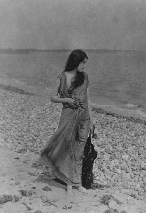 elevenacres:circa 1899: A windswept woman strolls along a pebble beach. (Photo by Hulton Archive/Get