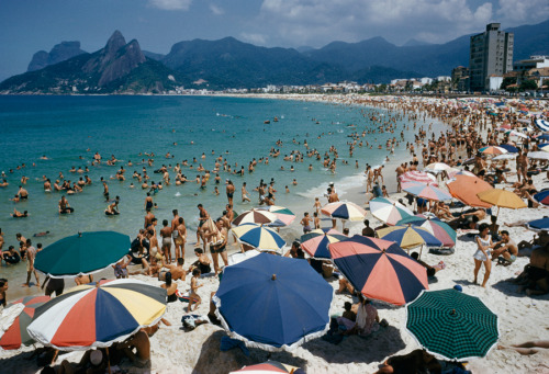 Umbrellas and swimmers dot Arpoador Beach in Rio de Janiero, Brazil, March 1955.Photograph by Charle