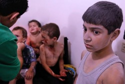 troposphera: Arbin, Syria     A child waits to receive treatment at a makeshift hospital after he was  injured by shelling in the rebel-held town of Arbin, east of the capital    Photograph: Abdulmonam Eassa/AFP/Getty Images 